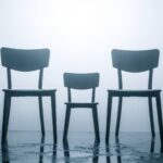 Trauer bewältigen nach Verlust: Drei leere Stühle symbolisieren den Tod von Großvater, Vater und Sohn